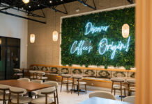 6 coffeehouses fueling Atlanta’s newfound love for Yemeni coffee A wall of plants with a neon sign reads "Discover Coffee's Origin!"