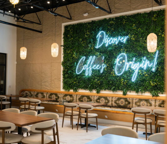 6 coffeehouses fueling Atlanta’s newfound love for Yemeni coffee A wall of plants with a neon sign reads "Discover Coffee's Origin!"