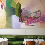 An abstract painting by Tommy Taylor defines the main dining room