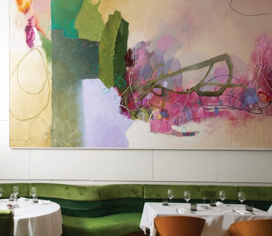 An abstract painting by Tommy Taylor defines the main dining room