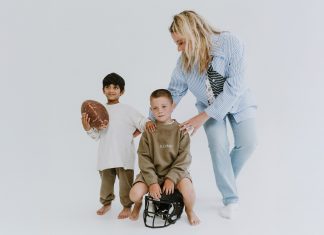 Former NBA courtside reporter Kristen Ledlow launches kids clothing brand two kids model the Positionless clothing next to Kristen Ledlow
