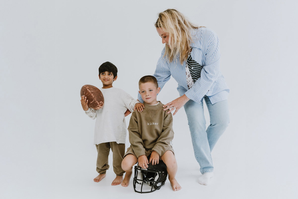 two kids model the Positionless clothing next to Kristen Ledlow