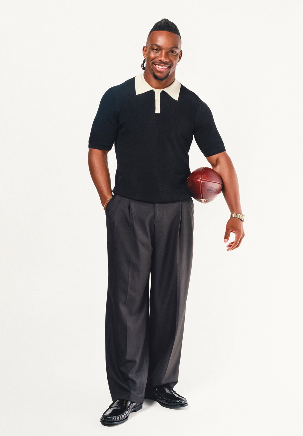 Bijan Robinson holds a football against a white backdrop