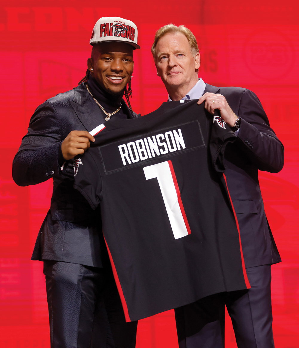 Robinson posing with NFL Commissioner Roger Goodell at the 2023 NFL Draft