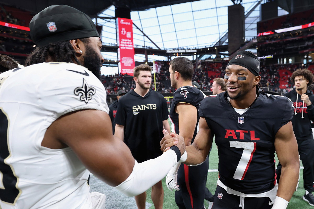 Robinson (right) meeting Jaylan Ford of the New Orleans Saints after a January game