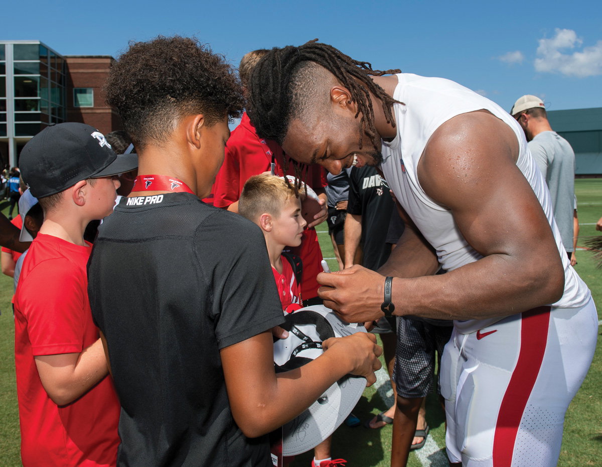 Robinson signing an autograph at Falcons training camp