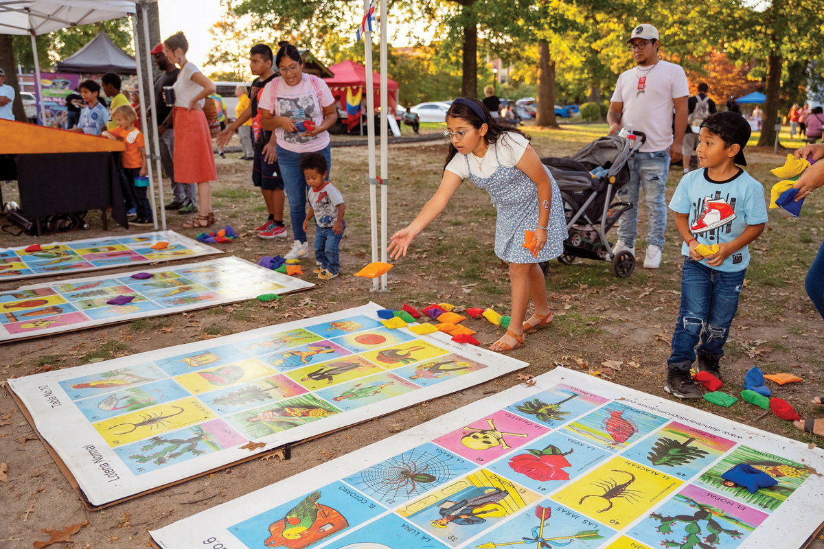 kids play knapsack on a giant loteria board at the Día de Muertos Celebration