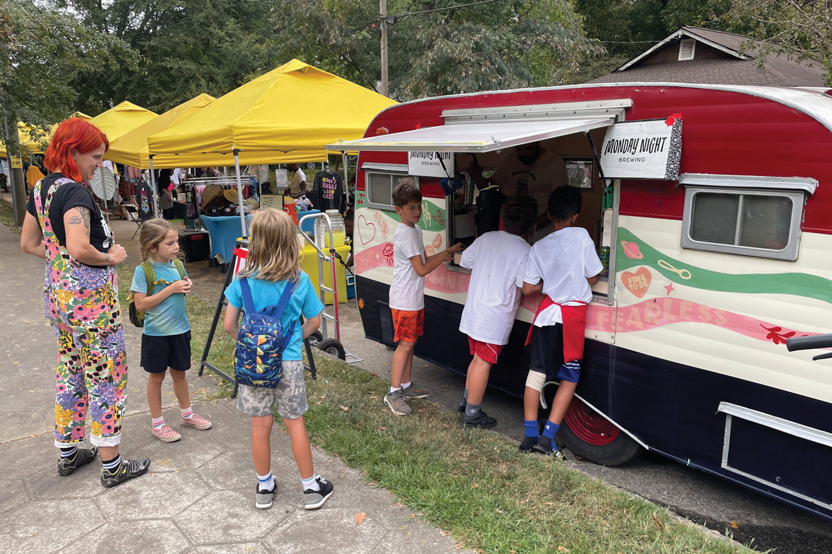 kids wait outside a food truck at the Porches & Pies Festival