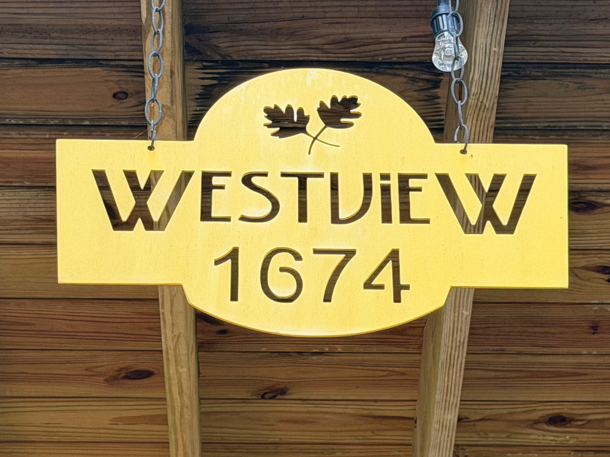 a yellow, carved sign reads "Westview 1674"