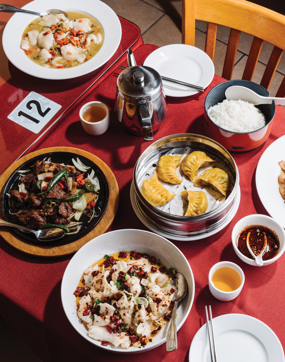 dishes from local chinese cuisine restaurant, Materpiece, arranged on a red table