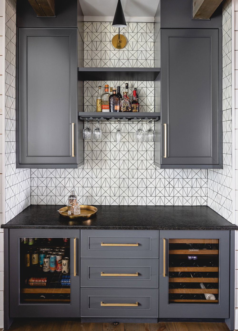 grey cabinets with gold accents against a patterned wall