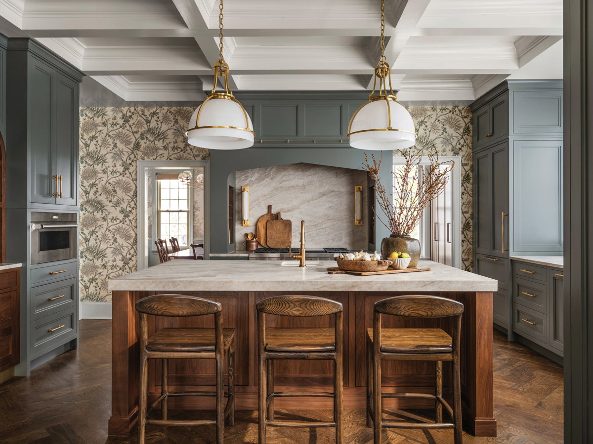 a rustic kitchen with a marble and wooden island in the middle and two overhead lamps above it