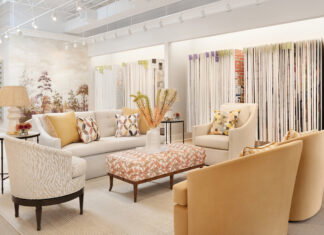 the inside of the cream and beige colored showroom with accent yellow chairs and an array of wallpapers to look through