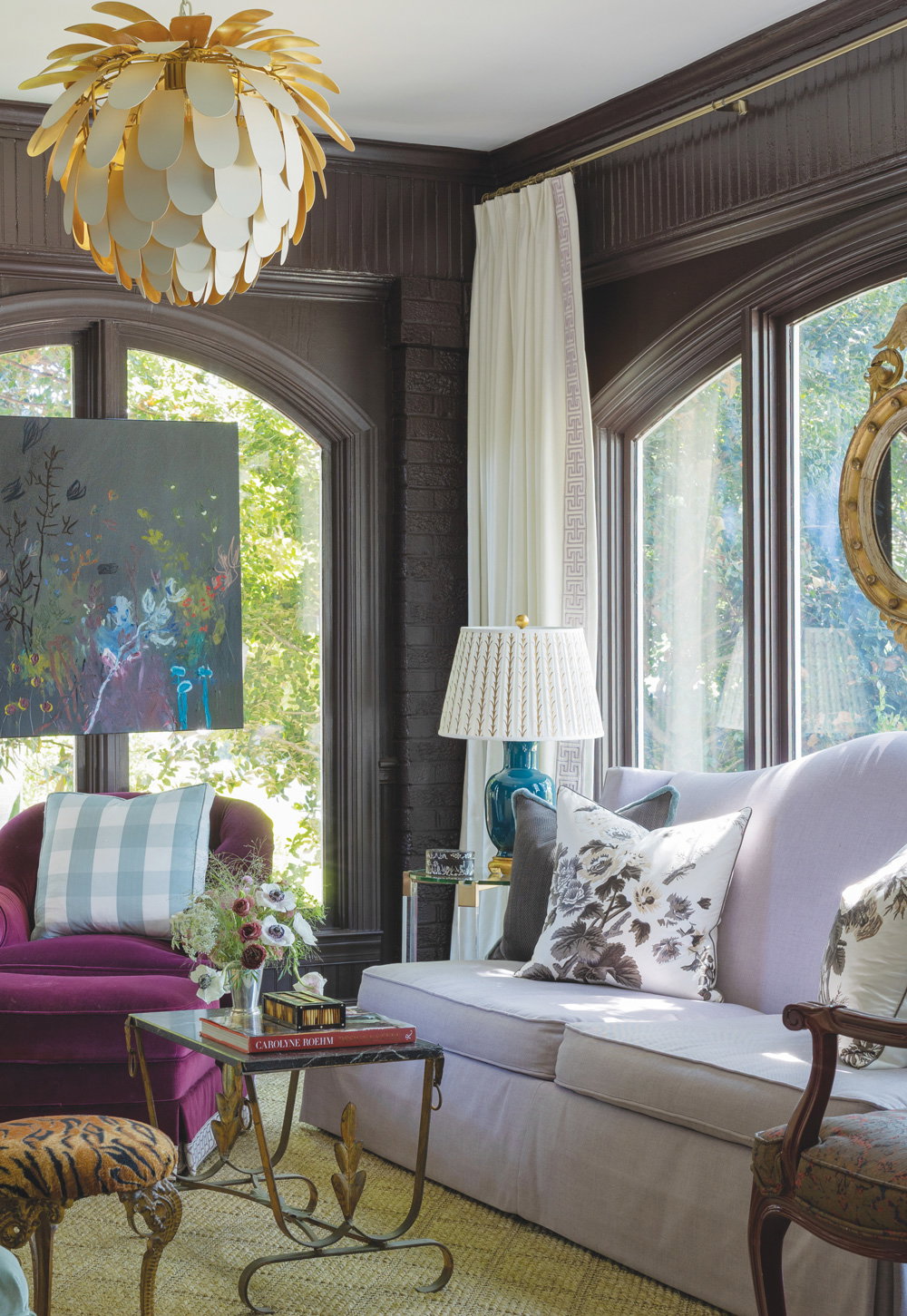 Deep chocolate brown envelops the collected sunroom
