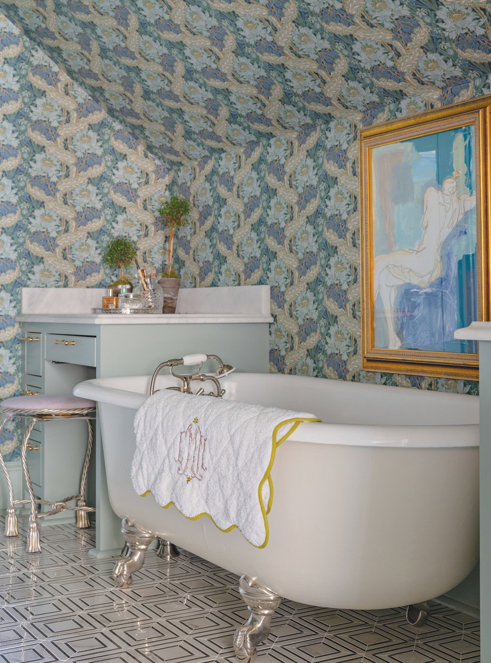 light blue cabinets with an original cast iron white and silver detailed clawfoot bathtub