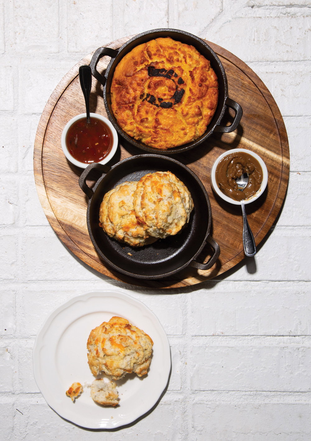 biscuts, gravy, and an array of other dishes over a white brick table