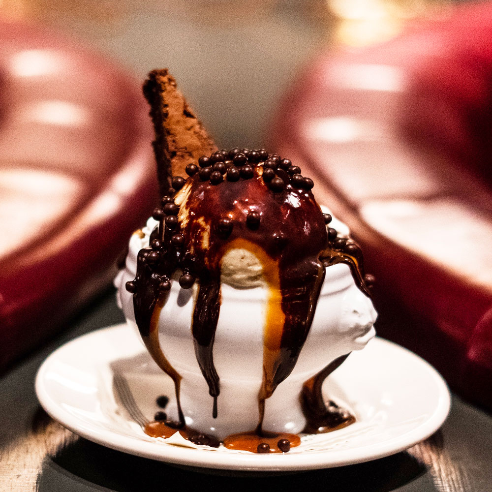 A small scoop of ice cream topped with a dollop of caviar