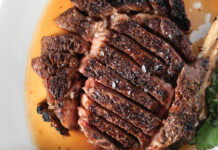 Yes, Atlanta is one of America’s best cities for steakhouses 24-ounce rib eye sits on a plate in a pool of juice