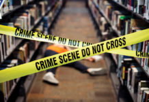 At this Decatur library, true crime lovers come together for Murder & Mocktails a person laid on the floor between two book isles is blocked off by yellow crime scene tape